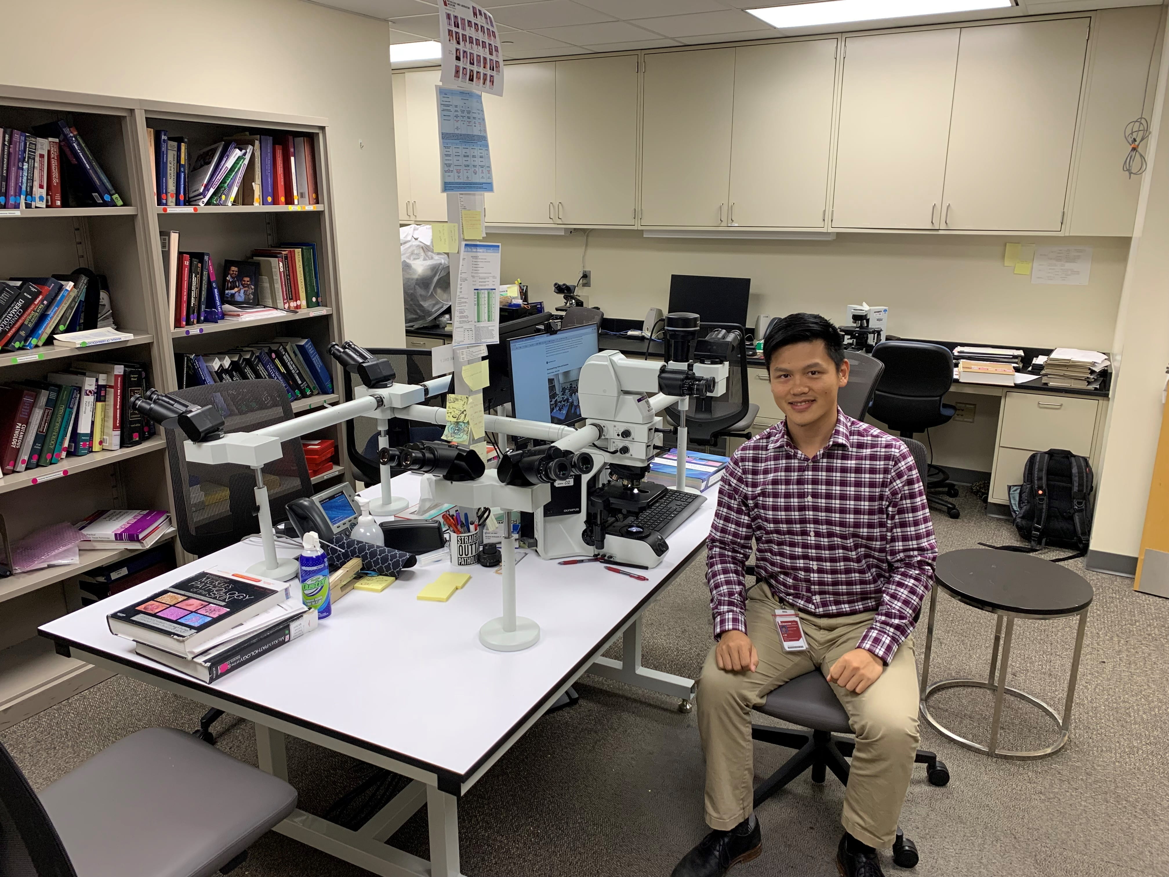 Current fellow Aofei Li sitting at desk