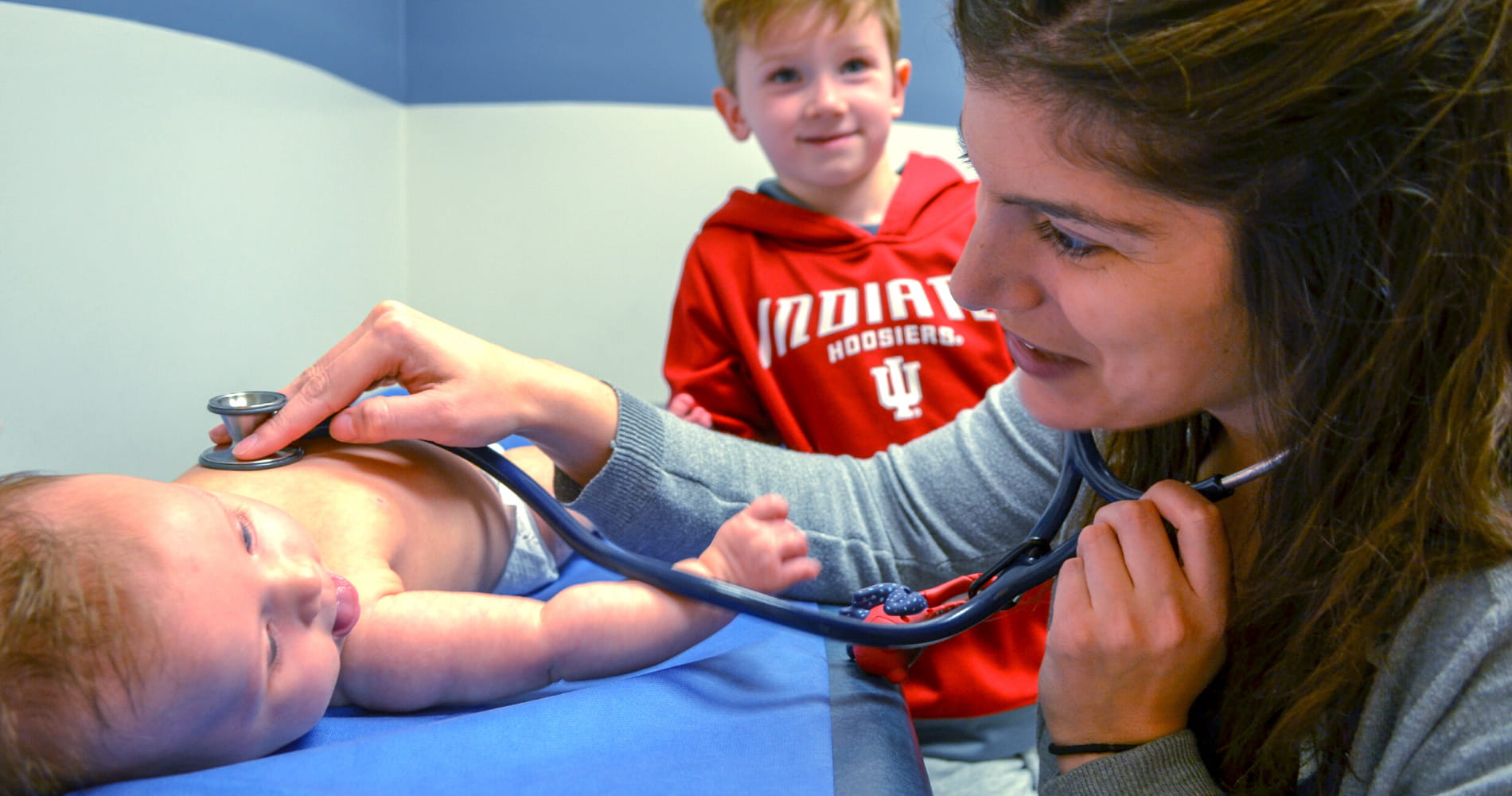 Pediatric resident interacting with a patient on the primary care service