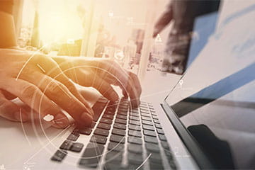 hands typing on a keyboard