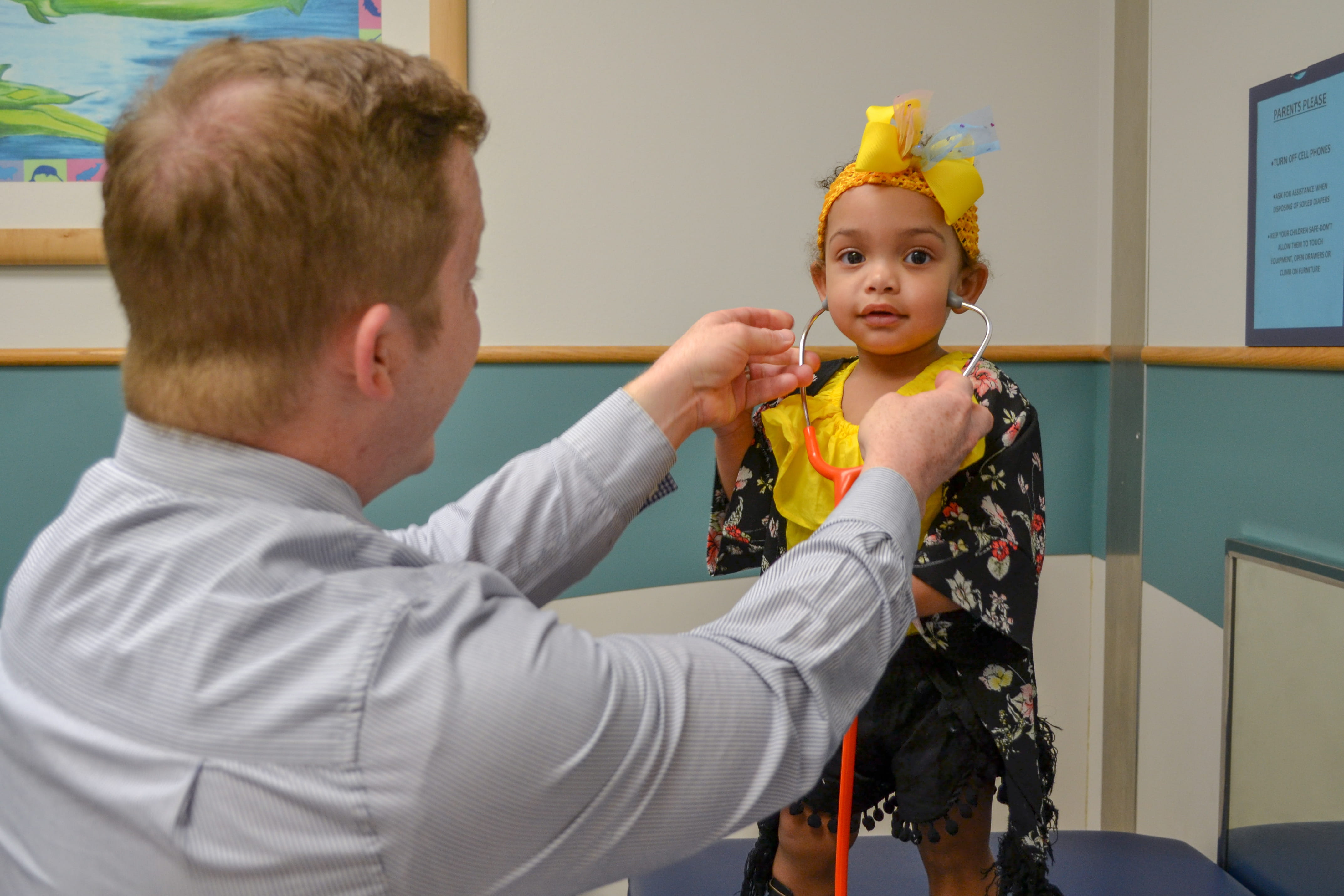 Dr. Huskins interacts with a young patient.