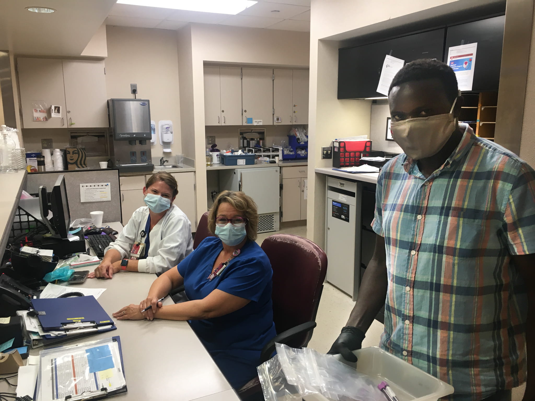 Eliud Odhiambo working on the TACTIC-2 study for the Ryan White Center