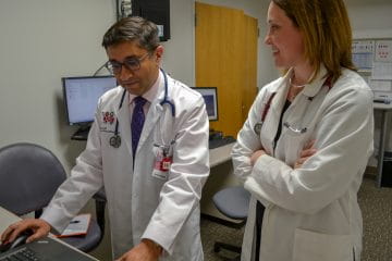 two researchers talk together about a project