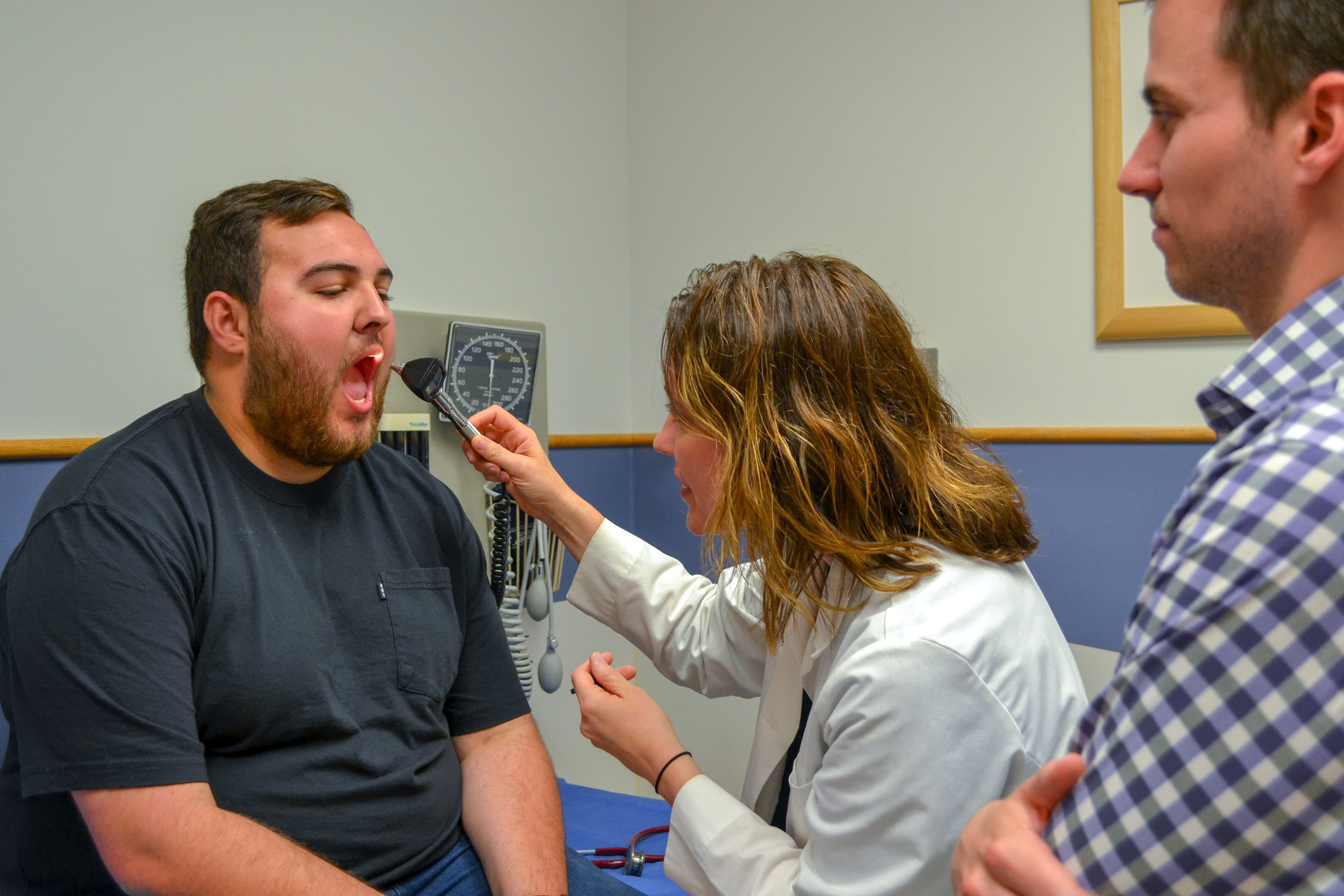 Kirsten Kloepfer, MD, works with a resident during an exam