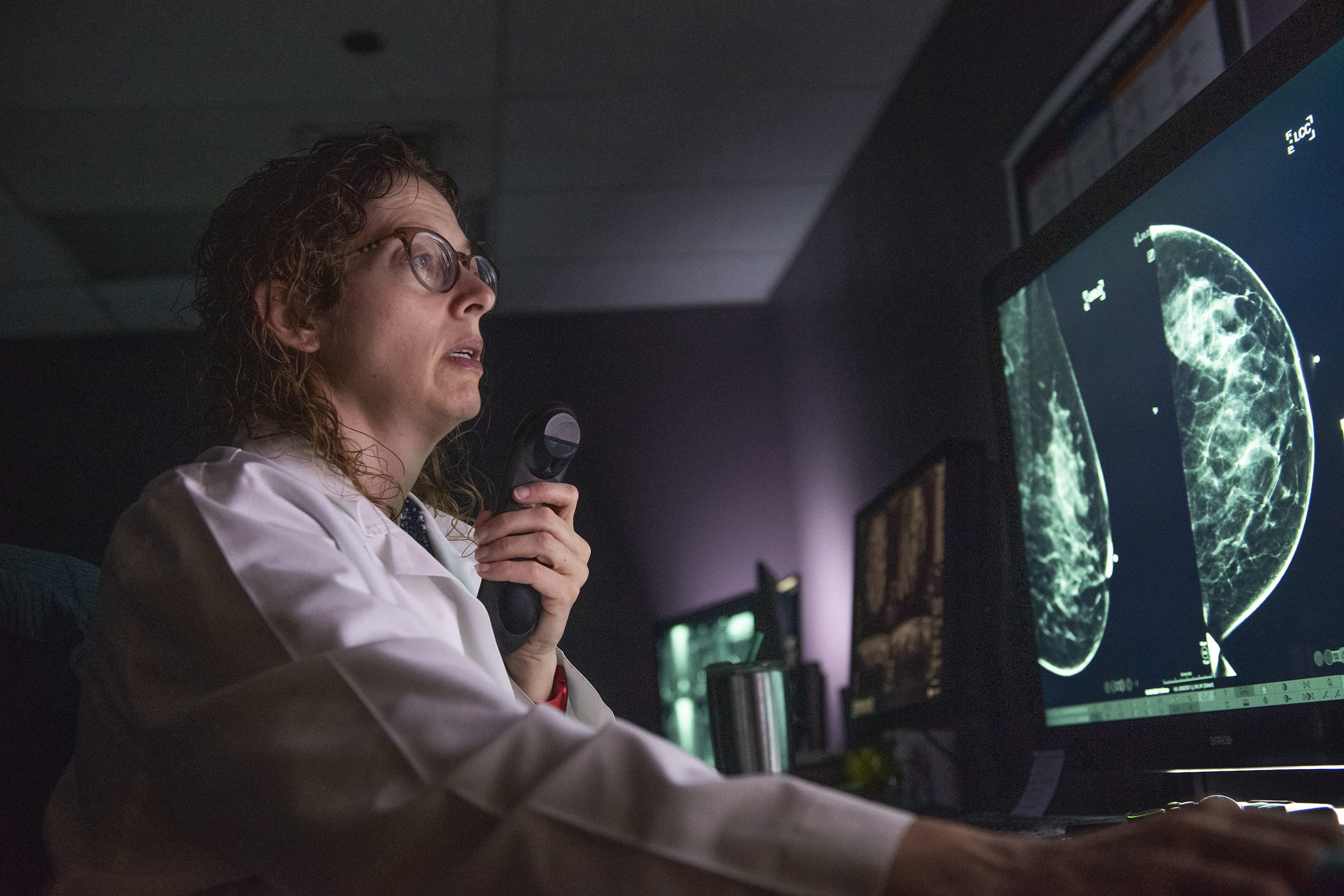 Individual looking at scans on a computer screen in a radiology reading room