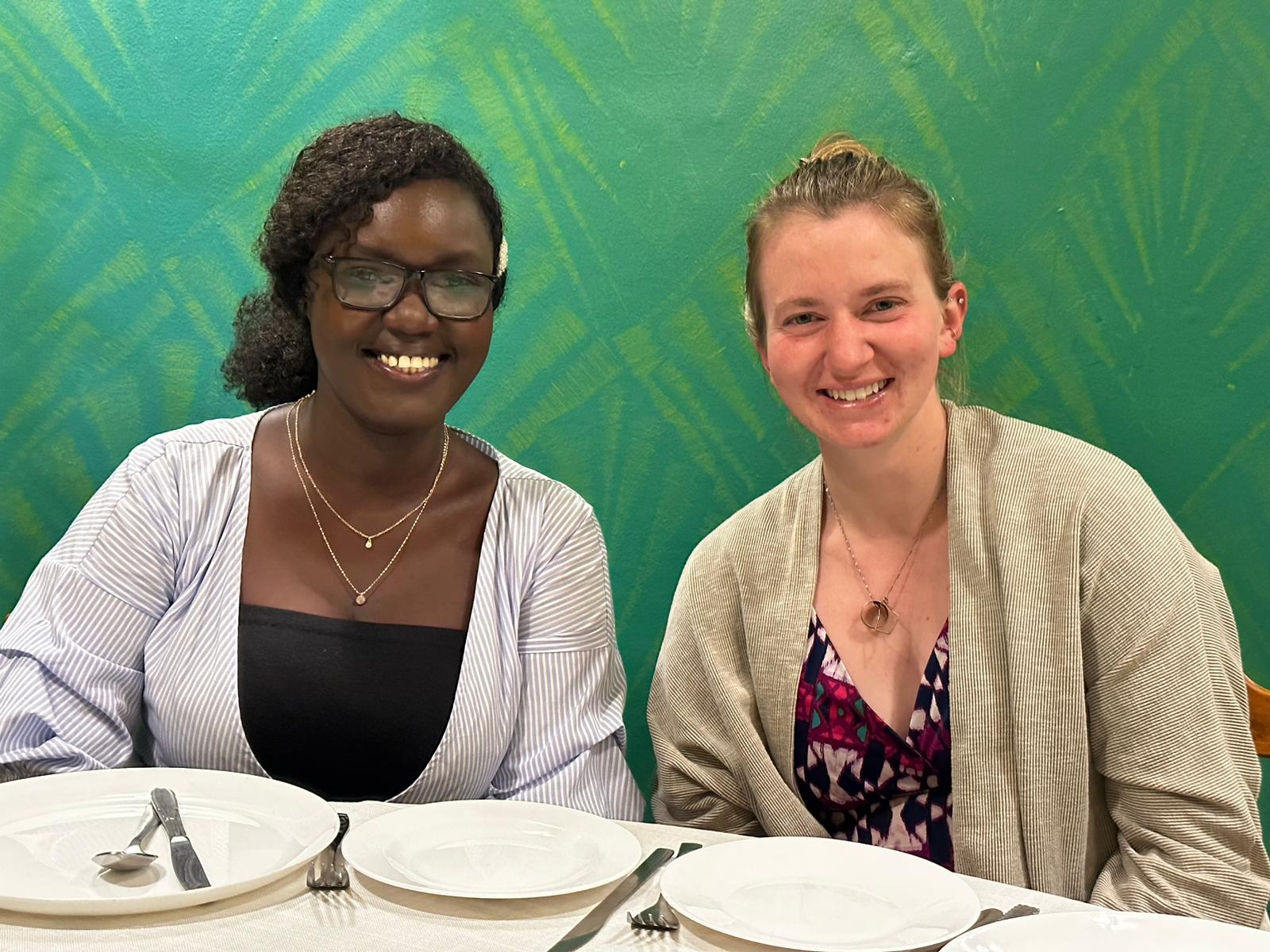 Surgery residents are seated at a table for a meal in Eldoret, Kenya. 