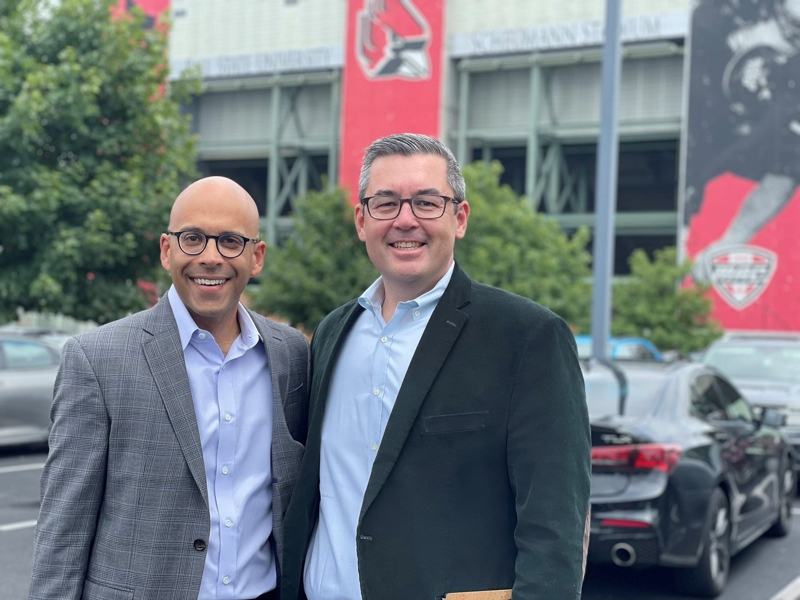 Left to right: Karl Y. Bilimoria, MD and Anthony L. Shanks, MD, MS, stand outside a stadium.