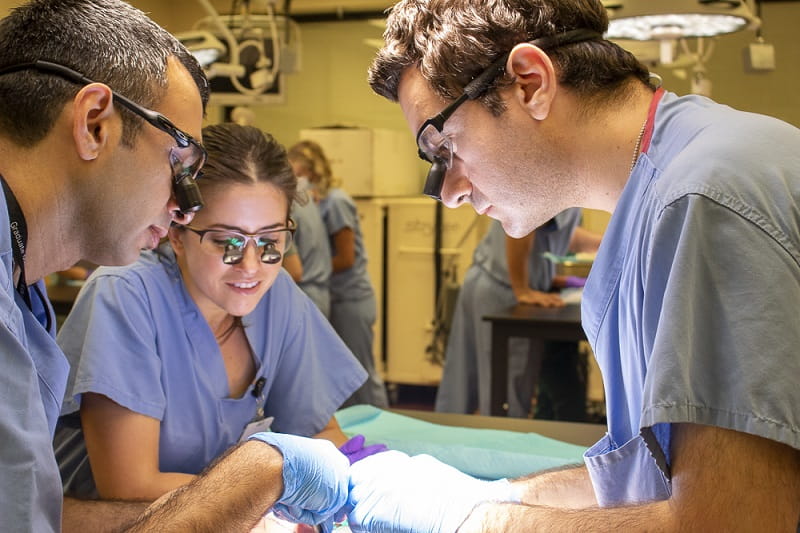 Photo of resident practicing surgery in a training lab