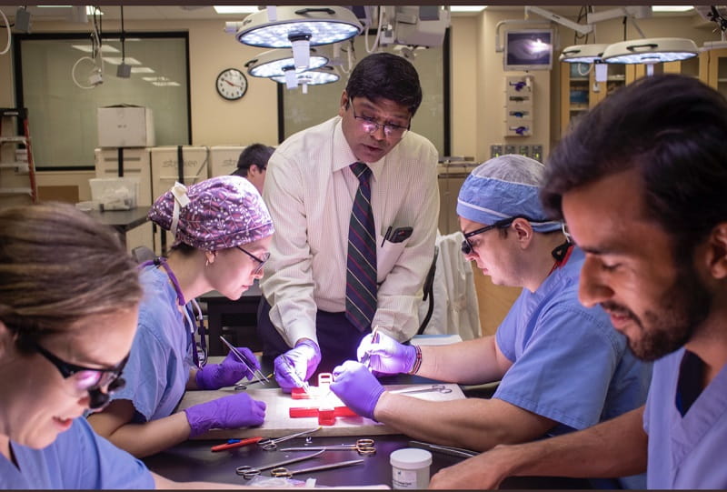Vascular surgery faculty member working with residents during a training lab