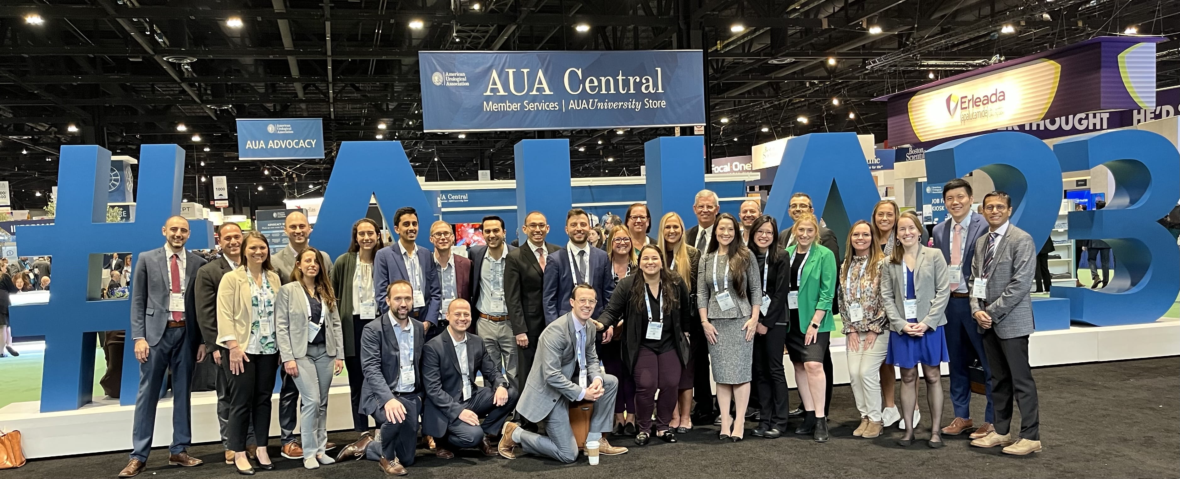 a large group photo of about 30 urology residents and faculty at a scientific conference