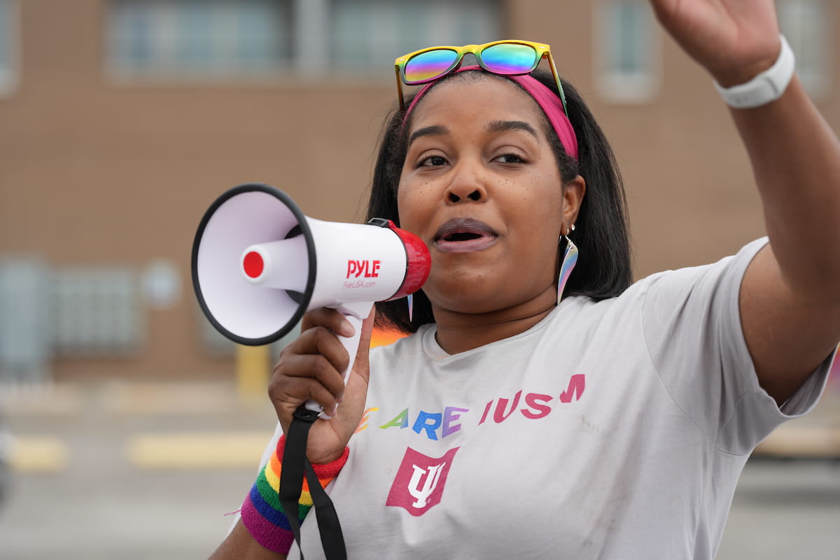 a black woman addresses the school of medicine contingent at the Indy Pride parade