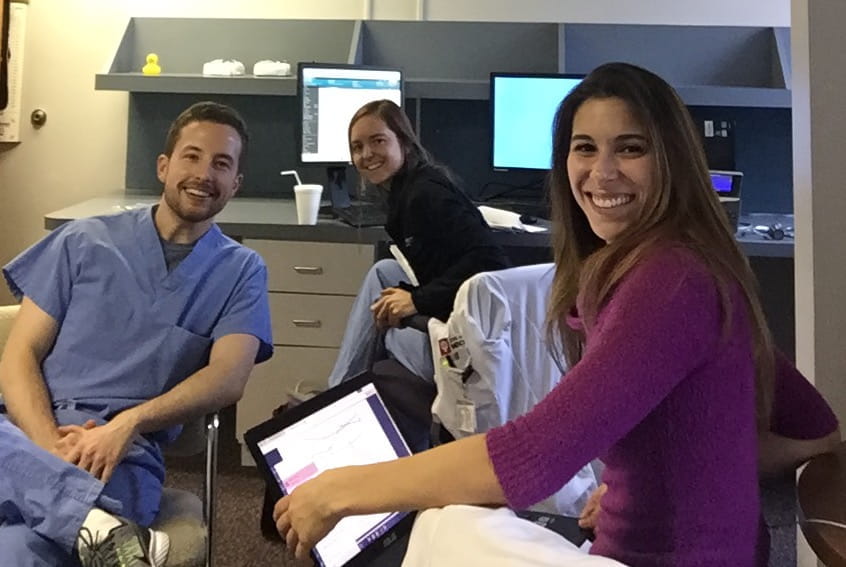three residents in a clinic work room in the hospital