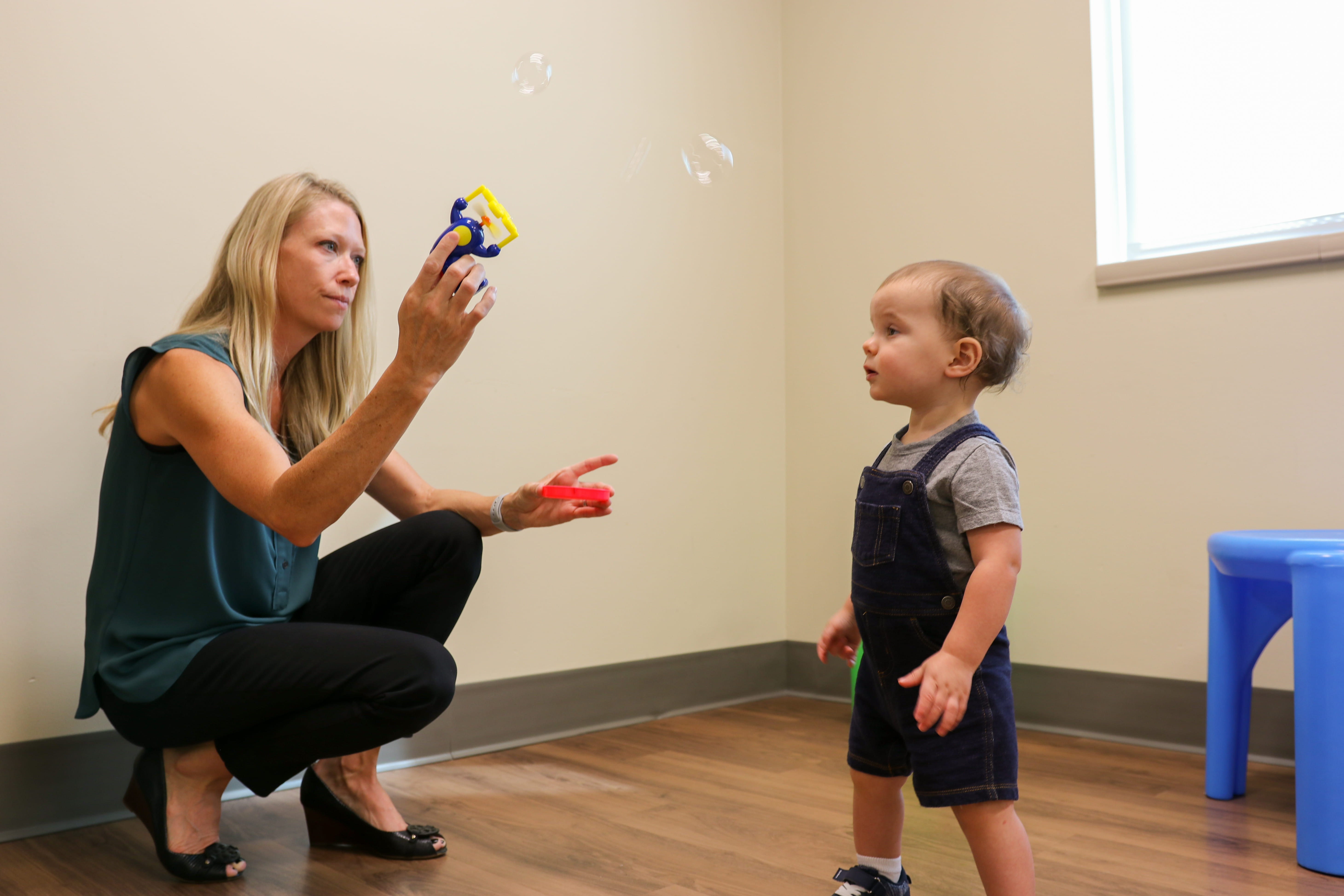 a provider and child play with bubbles