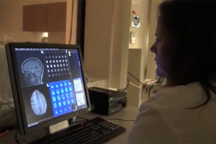 a person reviews brain imaging results in the lab