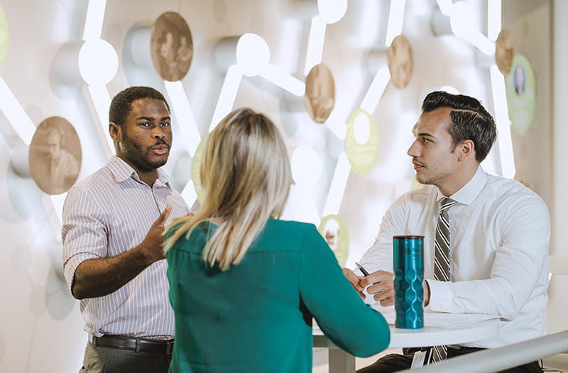 A group of individuals talk at Regenstrief Institute