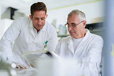 Two men discuss research