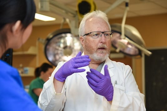 a teaching speaks to students in anatomy lab