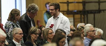 families interact with a medical student at the body donation memorial ceremony
