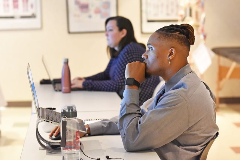 two students at the muncie campus listen intently during a classroom lecture