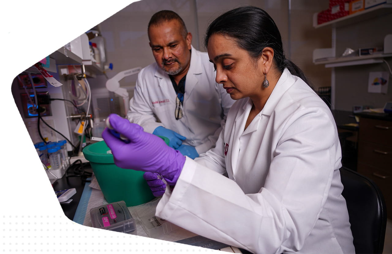 two researchers collaborating to prepare samples in the lab