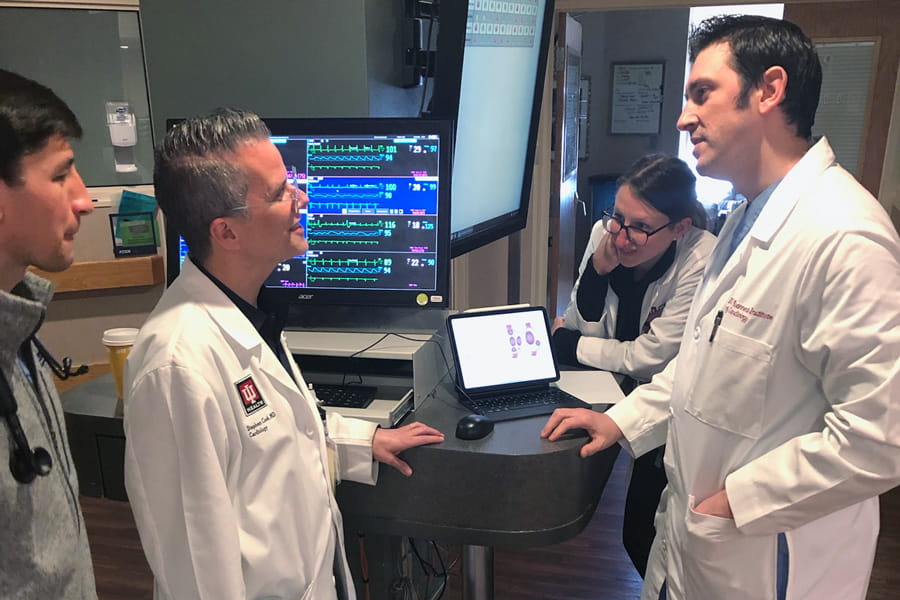 clinical faculty and fellows discuss a case