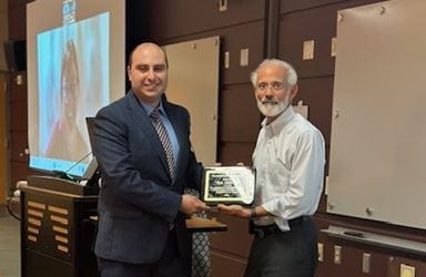 Division Director Michael Econs, MD, presents an award to Wade Jodeh, MD.