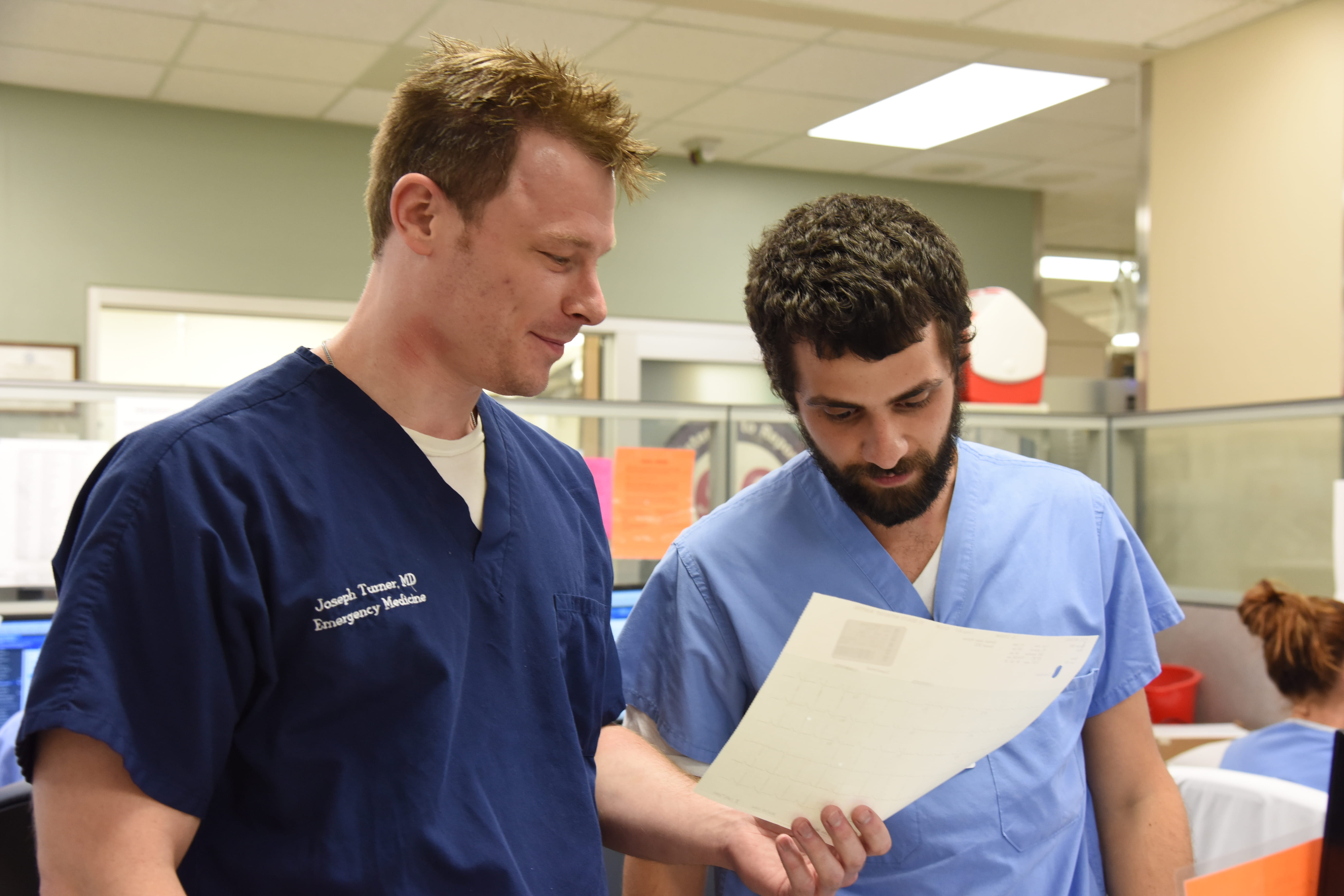 Two doctors discussing a patient chart. 