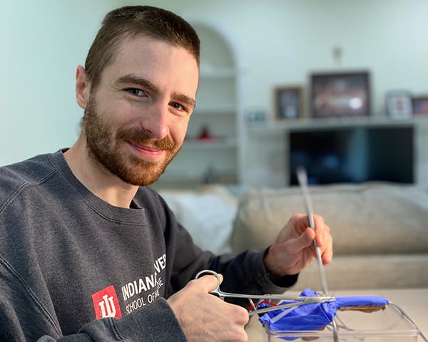 IU School of Medicine student Joshua Matthews uses a model to demonstrate appendectomy surgery