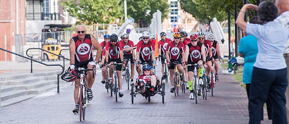 a group of cyclist rides towards the camera