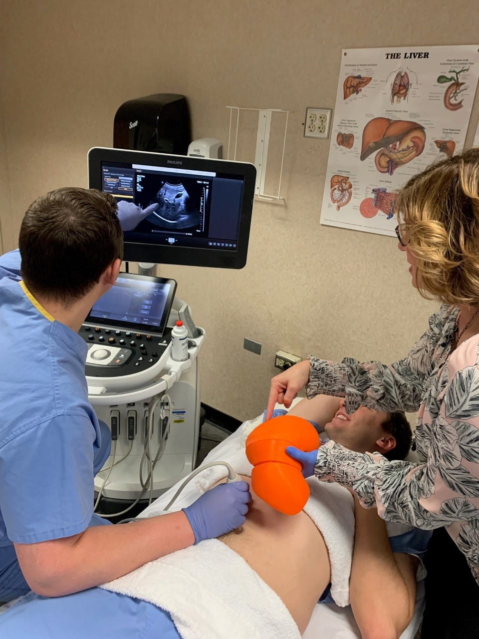 Professor Dina Peterson using a 3D-printed liver printed in the Ruth Lilly Medical Library's Makerspace while teaching a student.