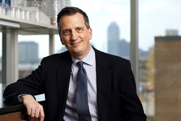Bruce Lamb, a white man, wearing a dark suit jacket and tie