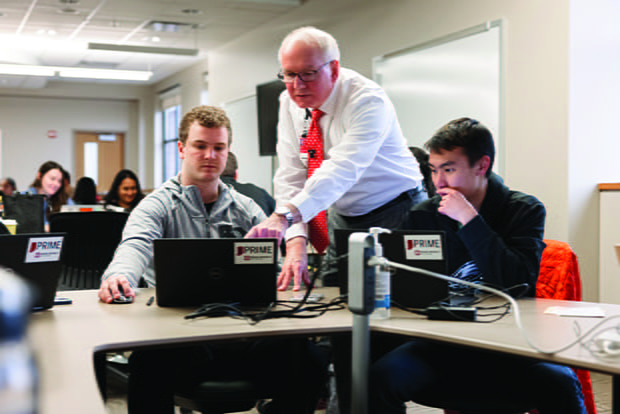 Jay Hess working with students in class