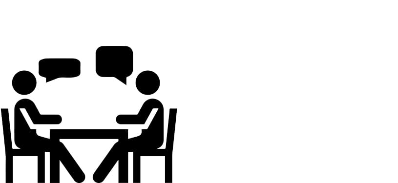 two people talking together at a table