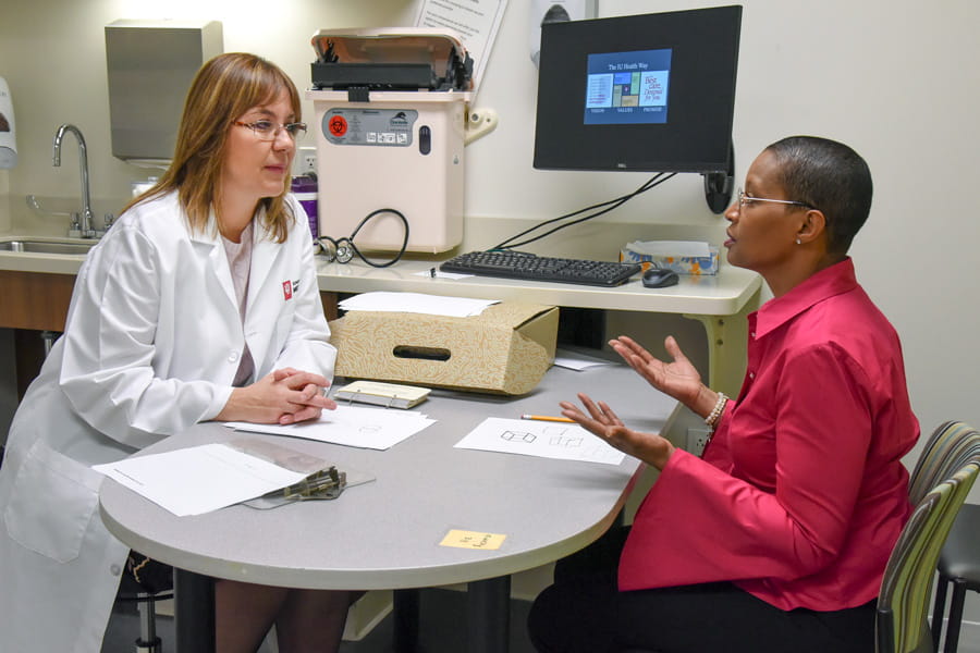 Liana Apostolova listens to a patient from her research study