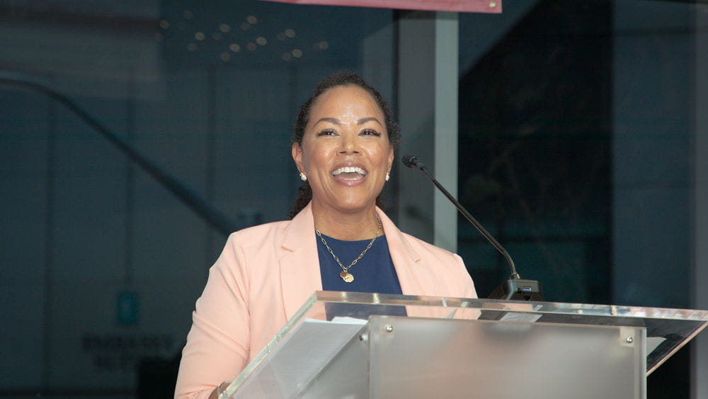 Chemen Neal speaks at a podium