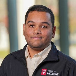 Shubham wearing a black sweater with the IU School of Medicine logo.