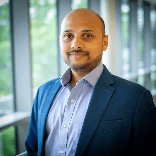 Dr. Shiradkar wearing a dark jacket and button up shirt