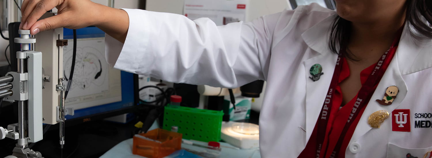 Pathology worker using lab equipment