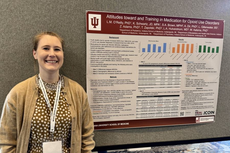 Lauren O'Reilly presenting a poster at a conference