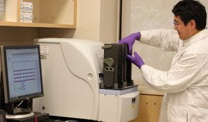 a staff scientist at work in the chemical genomics core